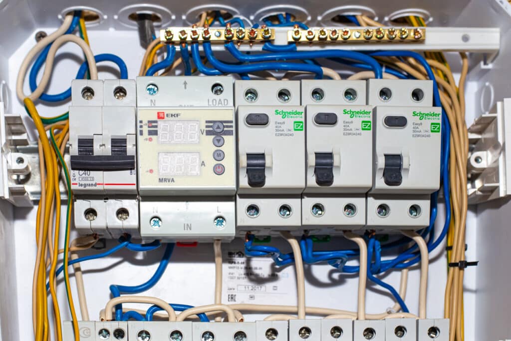 Electrical panel with switches and wires.