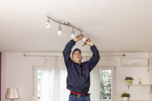 man changing energy saving light